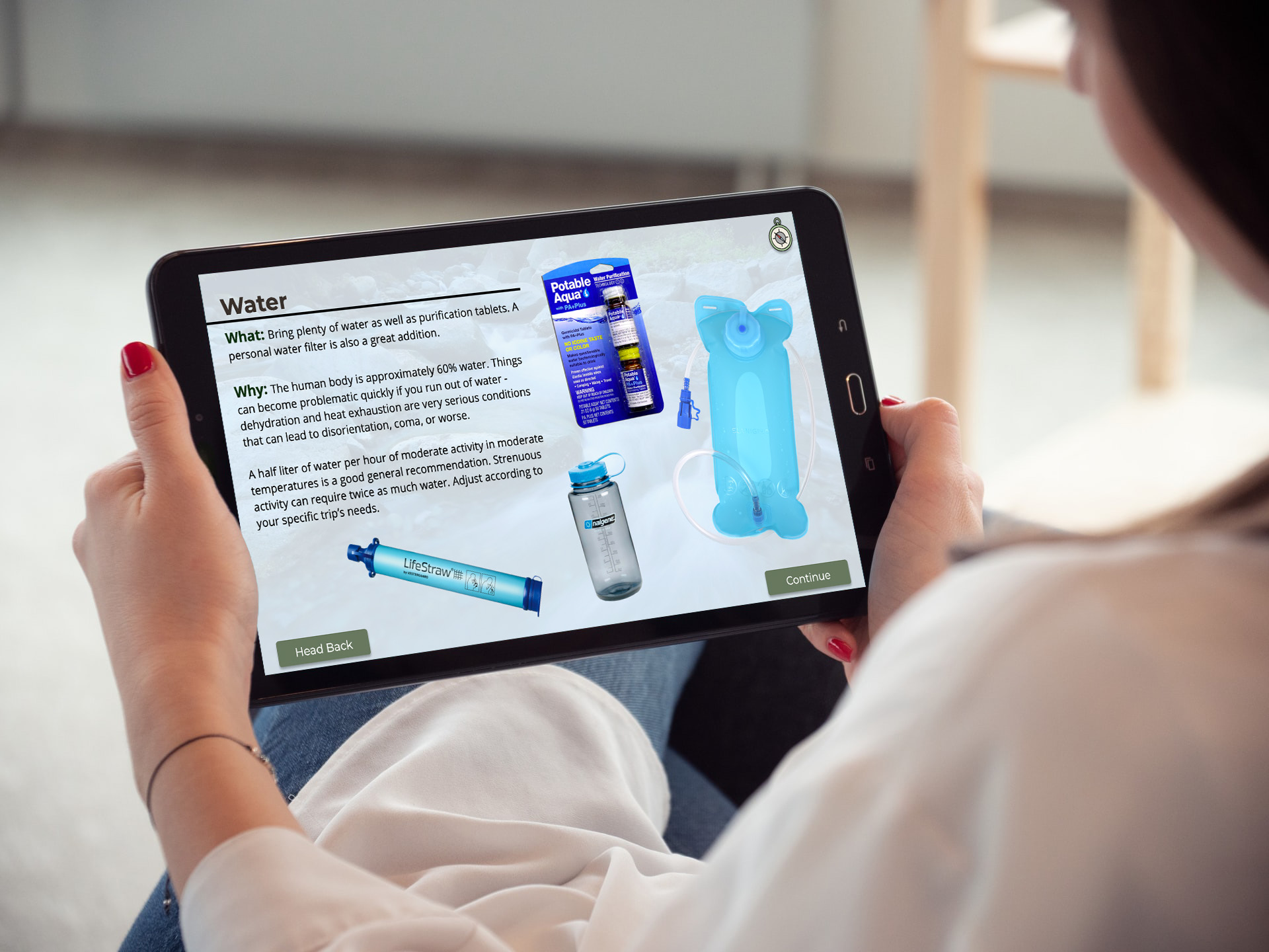 Person holding tablet with essentials learning experience on screen